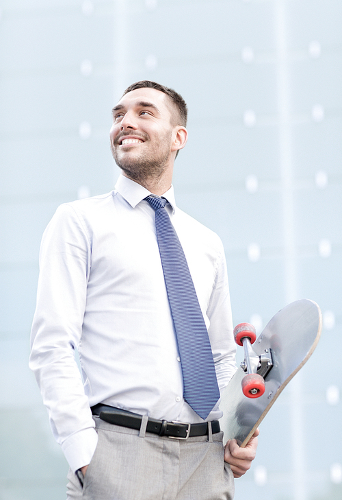 business, hot drinks and people and concept - young smiling businessman with skateboard outdoors