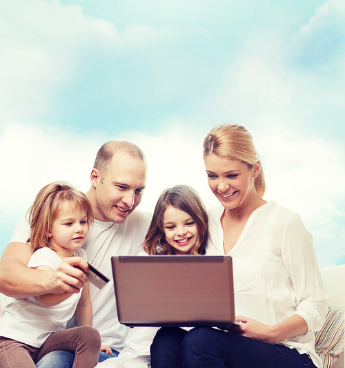 family, shopping, technology and people - happy family with laptop computer and credit card over blue sky background