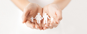 close up of woman cupped hands showing paper man family