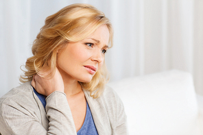 people, healthcare and problem concept - unhappy woman suffering from neck pain at home