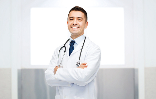 healthcare, profession, people and medicine concept - smiling male doctor in white coat with stethoscope