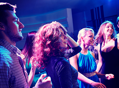 party, holidays, celebration, nightlife and people concept - smiling friends dancing in club