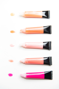 cosmetics, make up and beauty concept - close up of lip gloss tubes