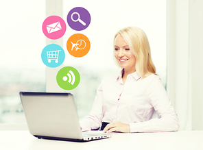 business, people and technology concept - smiling businesswoman or secretary with laptop computer and internet icons in office