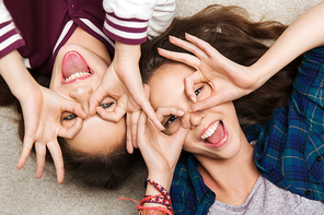 people, friends, teens and friendship concept - happy smiling pretty teenage girls having fun and making faces