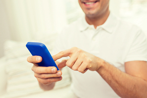 technology, people, lifestyle and communication concept - close up of happy man with smartphone at home