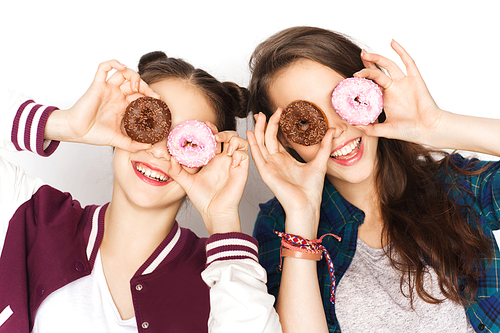 people, friends, teens and friendship concept - happy smiling pretty teenage girls with donuts making faces and having fun