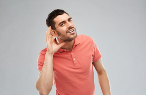 gesture and people concept - latin man having hearing problem listening to something