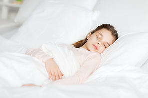 people, children, rest and comfort concept - girl sleeping in bed at home