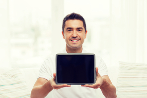technology, people and lifestyle, distance learning concept - happy man showing tablet pc computer black blank screen at home