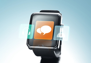 modern technology, communication, object and media concept - close up of black smart watch with text bubble icon on screen over blue background