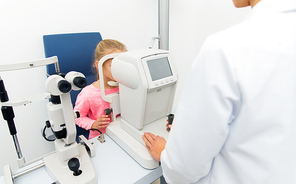 health care, medicine, people, eyesight and technology concept - optometrist with autorefractor checking patient vision eye clinic or optics store