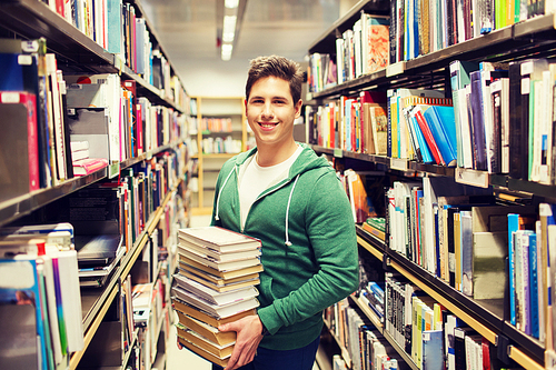 people, knowledge, education, literature and school concept - happy student or young man with book in library