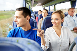 transport, tourism, road trip and people concept - happy couple with group of happy passengers or tourists in travel bus