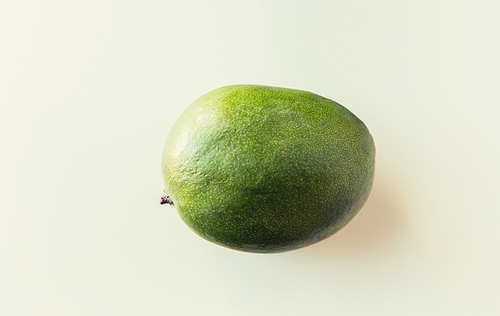 fruits, diet,  food and objects concept - ripe green mango over white