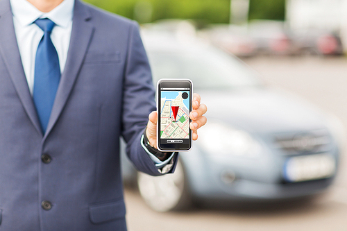 transport, business trip, technology, navigation and people concept - close up of man showing smartphone gps navigator map on screen on car parking