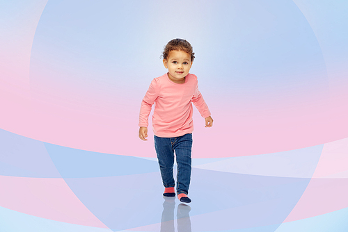 childhood, fashion, clothing and people concept - beautiful little african american baby girl walking over pink violet background