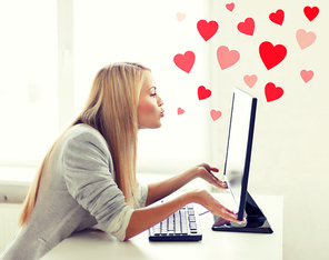 virtual relationships, online dating and social networking concept - woman sending kisses with computer monitor
