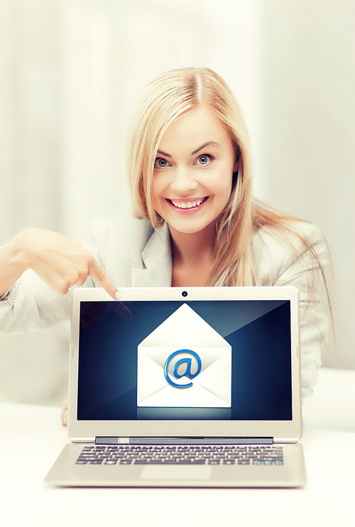 beautiful woman with laptop pointing at email sign