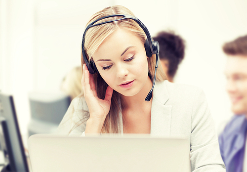 business and technology concept - helpline operator with headphones in call centre