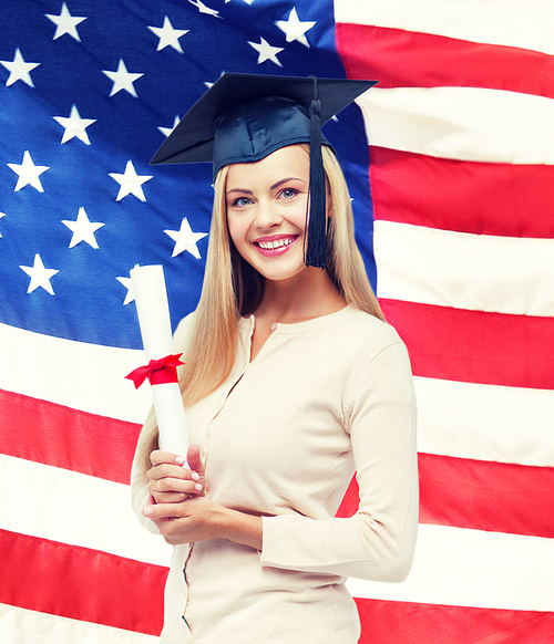 happy student in graduation cap with certificate over american flag