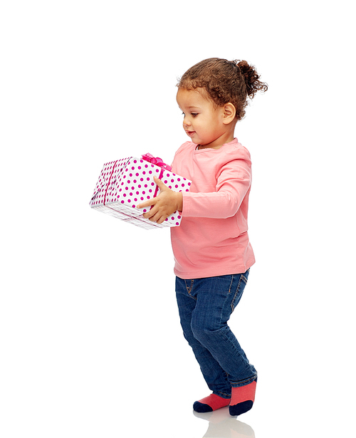 childhood, fashion, birthday, holidays and people concept - beautiful little african american baby girl walking with gift box