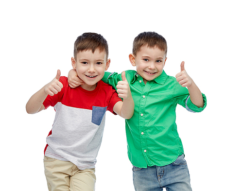 childhood, fashion, friendship and people concept - happy smiling little boys showing thumbs up