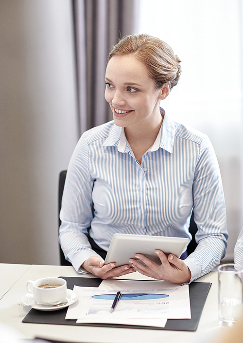 business, people and technology concept - smiling woman with tablet pc computer, papers and cup of coffee in office