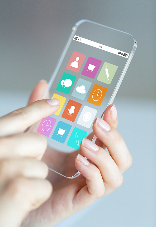 business, technology and people concept - close up of woman hand holding and showing transparent smartphone with application icons on screen