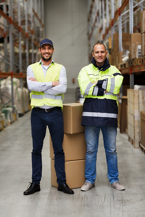 logistic, delivery, shipment, people and export concept - happy men or manual workers with boxes at warehouse