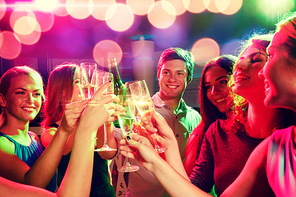 party, holidays, celebration, nightlife and people concept - smiling friends clinking glasses of champagne and beer in club