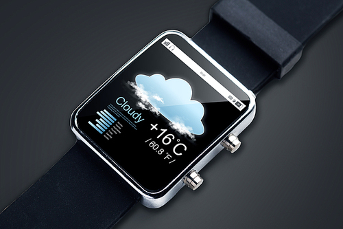modern technology, objectm, weather and media concept - close up of black smart watch with forecast app and air temerature on screen