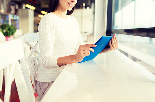 people, technology and lifestyle concept - close up of smiling woman with tablet pc computer at cafe