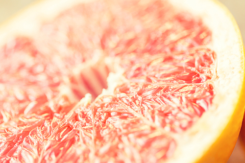 healthy eating, food, fruits and diet concept - close up of fresh juicy grapefruit slice