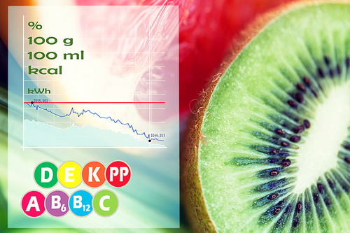 diet, food, healthy eating and objects concept - close up of ripe kiwi and grapefruit slices with calories and vitamins chart