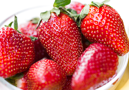 fruits, berries, weight loss,  food and objects concept - close up of fresh ripe red strawberries over white