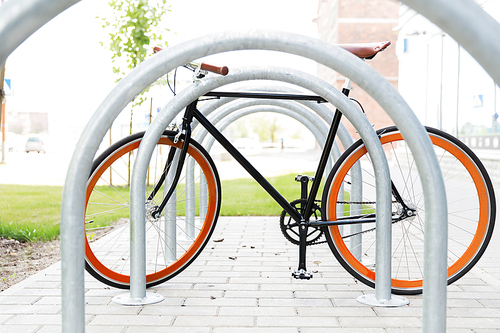 transport, storage and vehicle concept - close up of fixed gear bicycle at street parking outdoors