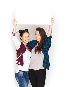 people, friends, teens and friendship concept - happy smiling pretty teenage girls holding and showing white blank board