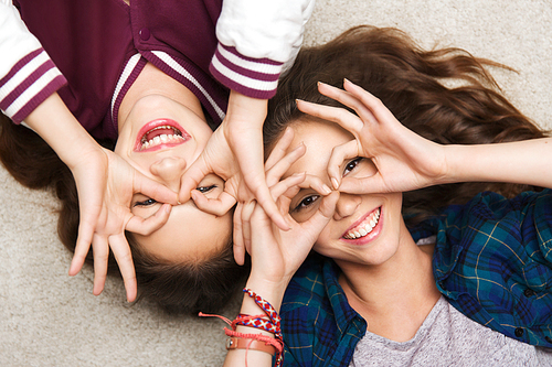 people, friends, teens and friendship concept - happy smiling pretty teenage girls having fun and making faces