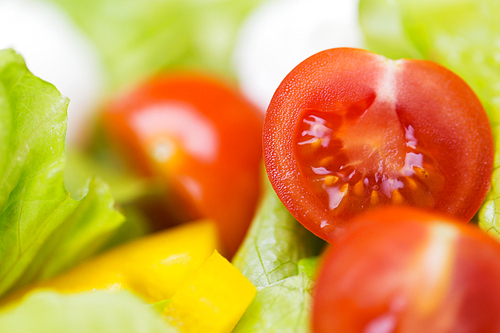 diet, vegetable food, healthy eating and objects concept - close up of ripe cut vegetables in salad