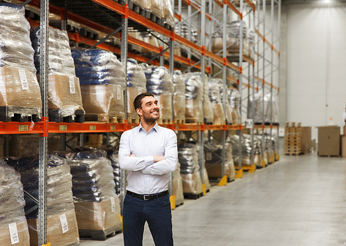 wholesale, logistic, business, export and people concept - happy man at warehouse