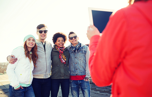 friendship, technology and people concept - group of happy teenage friends in sunglasses with tablet pc computer photographing outdoors