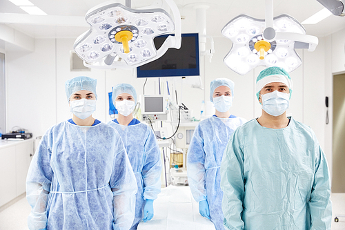 surgery, medicine and people concept - group of surgeons in operating room at hospital