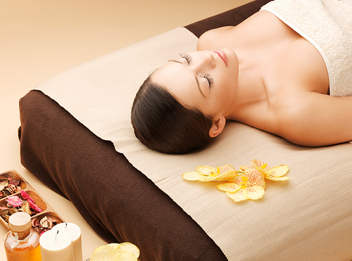 picture of woman in spa salon lying on the massage desk