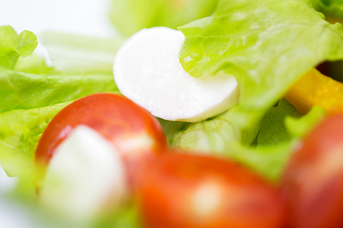 diet, vegetable food, healthy eating and objects concept - close up of vegetable salad with mozzarella cheese