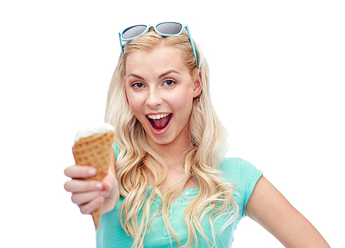 summer, junk food and people concept - young woman or teenage girl in sunglasses eating ice cream