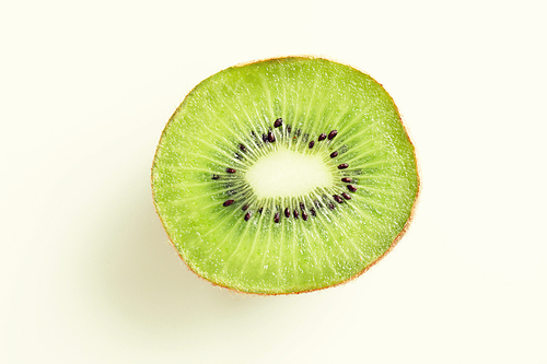 fruits, diet, food and objects concept - close up of ripe kiwi slice on table