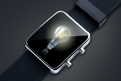 technology, startup, idea and business concept - close up of black smart watch with light bulb on screen