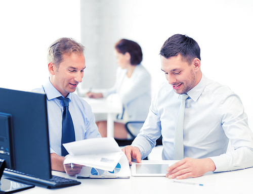 businessmen with notebook and tablet pc discussing graphs on meeting