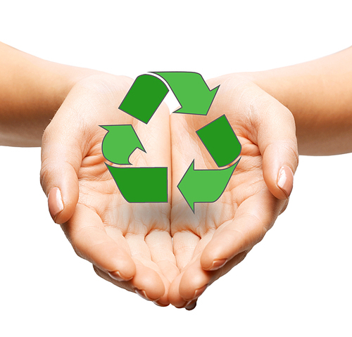 people, ecology, environment and conservation concept - close up of hands holding green recycling sign